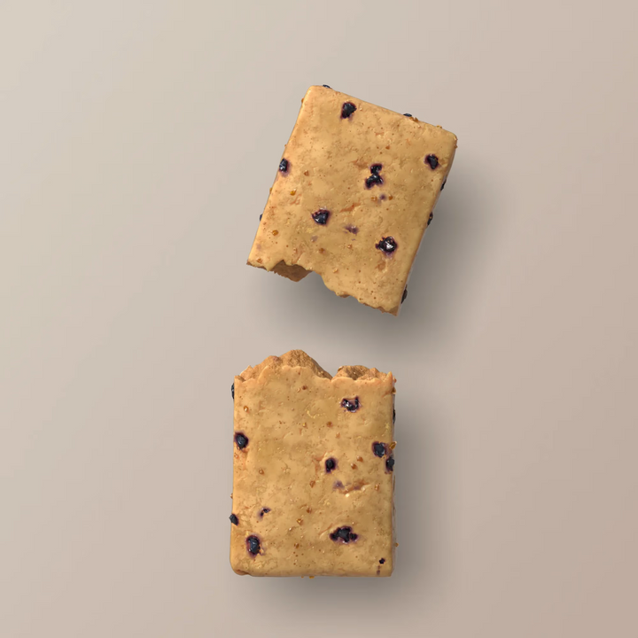 Close-up of Stars + Honey Maple Blueberry Muffin collagen protein bar texture with blueberry pieces
