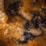 Close-up of Stars + Honey Maple Blueberry Muffin collagen protein bar flavor with blueberries and golden muffin pieces