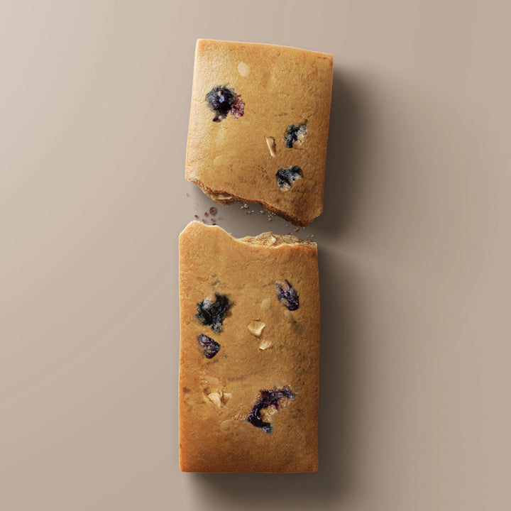 Close-up of Stars + Honey Peanut Butter Blackberry collagen protein bar pieces with blackberry