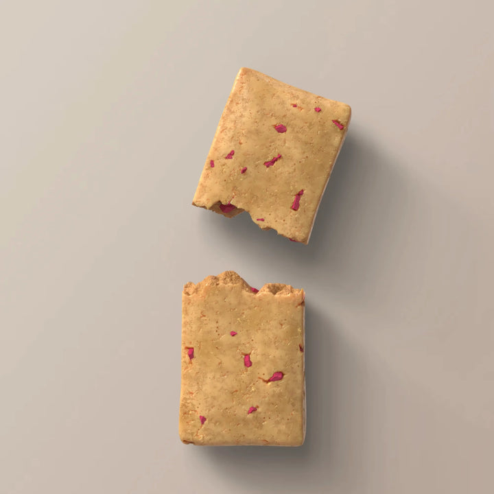 Close-up of Stars + Honey Raspberry Donut collagen protein bar pieces with raspberry