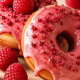 Raspberries and glazed donut representing Stars + Honey Raspberry Donut flavor