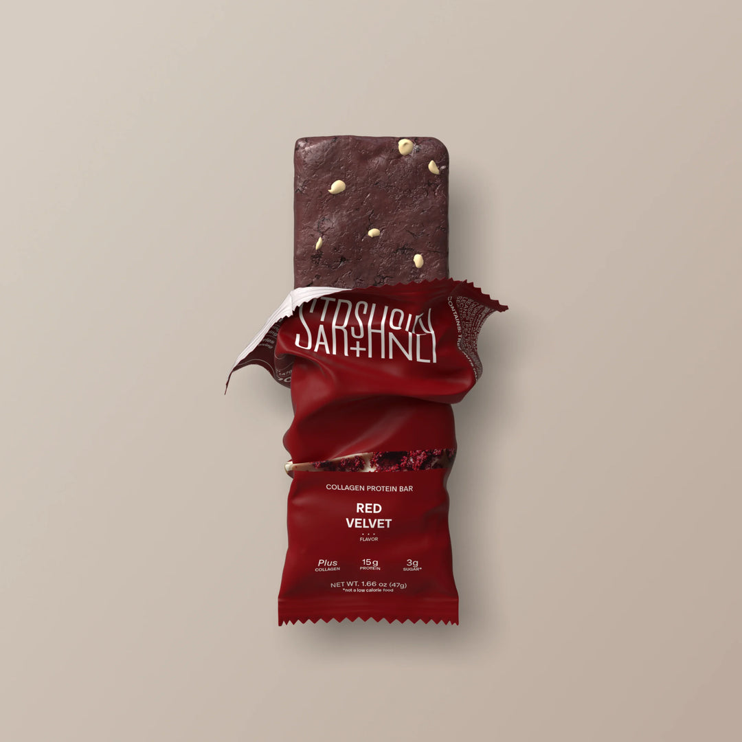 Stars + Honey Red Velvet collagen protein bar partially unwrapped