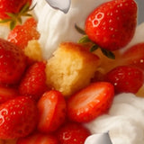 Close-up of Stars + Honey Strawberry Shortcake collagen protein bar flavor with strawberries, vanilla cream and golden cake pieces