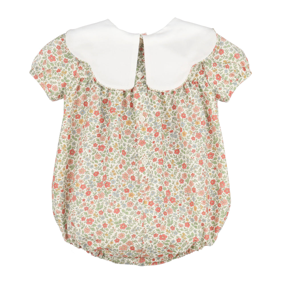 Back of Storybook Vintage Scallop Bubble with colorful floral print, white scalloped collar, and button closure