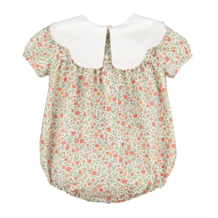 Back of Storybook Vintage Scallop Bubble with colorful floral print, white scalloped collar, and button closure