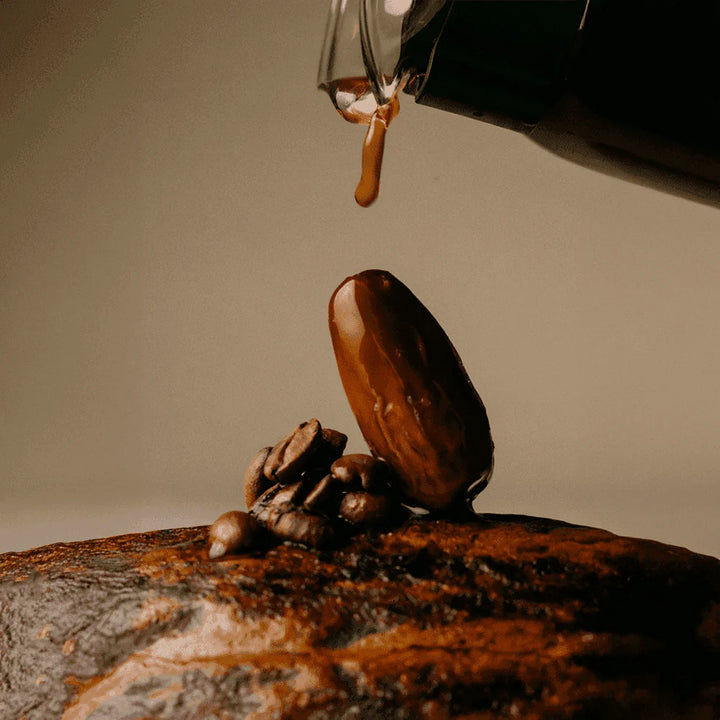 Coffee beans and chocolate-covered date with espresso drizzle for The Conscious Bar Espresso Crunch
