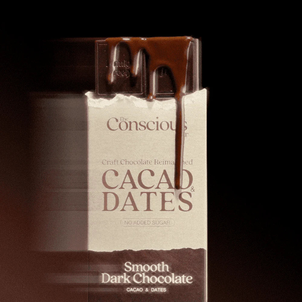 The Conscious Bar Smooth Dark Chocolate bar emerging from date-sweetened cacao and dates packaging