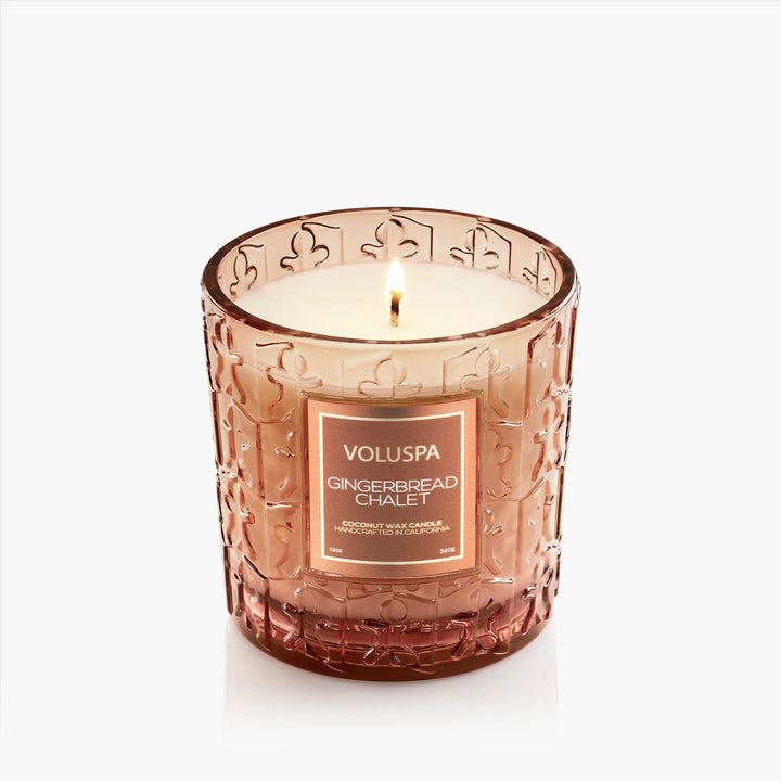 Lit Voluspa Gingerbread Chalet Luxe Classic Candle in embossed gingerbread glass vessel
