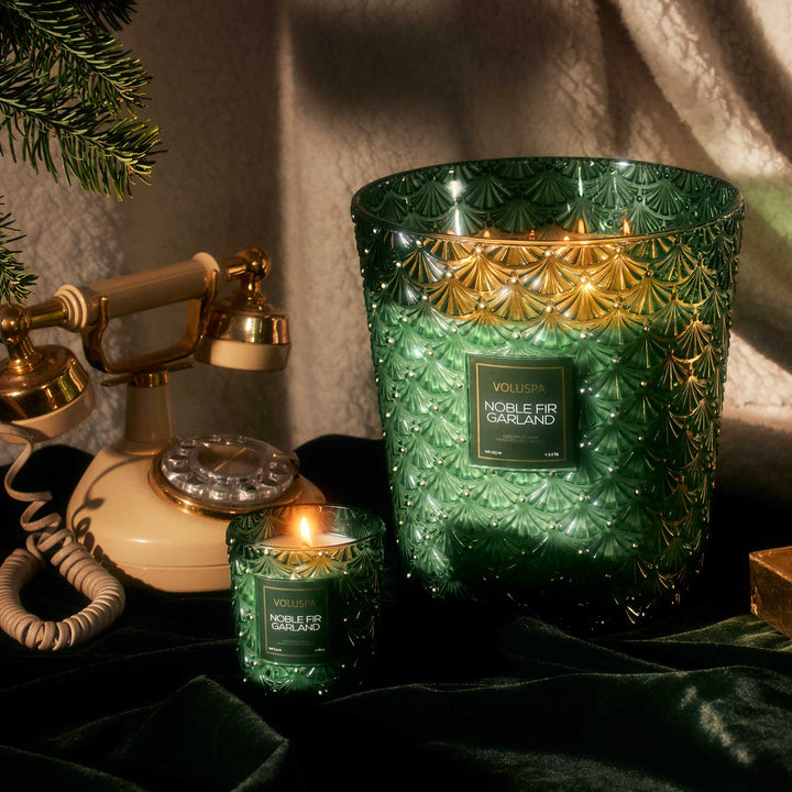 Voluspa Noble Fir Garland 5-Wick Hearth Candle displayed with festive evergreen holiday décor
