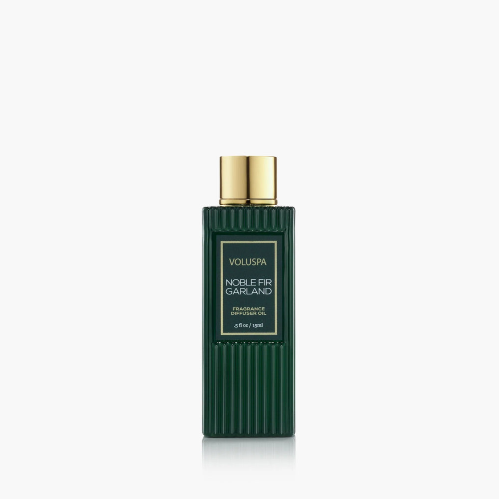 Voluspa Noble Fir Garland Ultrasonic Diffuser Fragrance Oil in a dark green bottle with gold cap