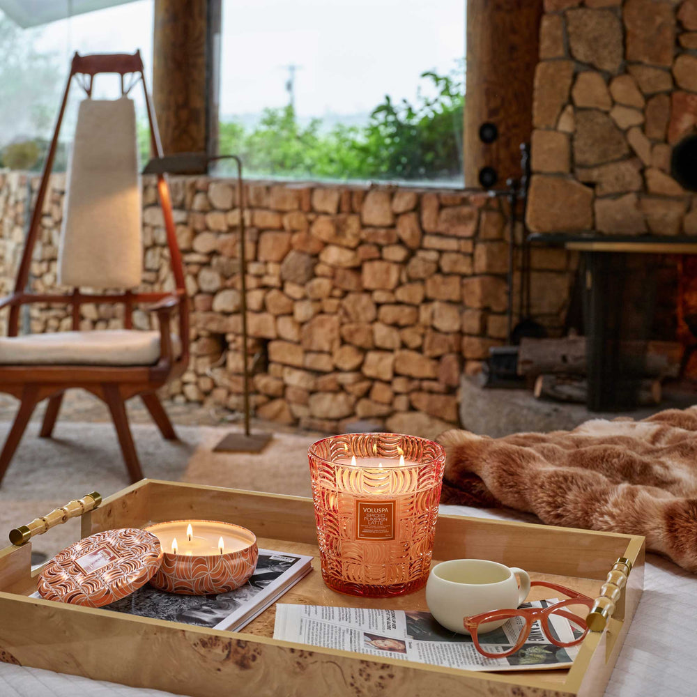 Voluspa Spiced Pumpkin Latte 3 Wick Tin Candle styled on a tray in a cozy fall living room