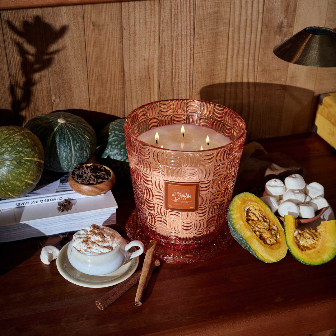 Voluspa Spiced Pumpkin Latte 5 Wick Hearth Candle styled with pumpkins, cinnamon sticks, and a pumpkin spice latte