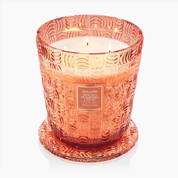 Lit Voluspa Spiced Pumpkin Latte 5 Wick Hearth Candle in embossed peach glass with decorative base