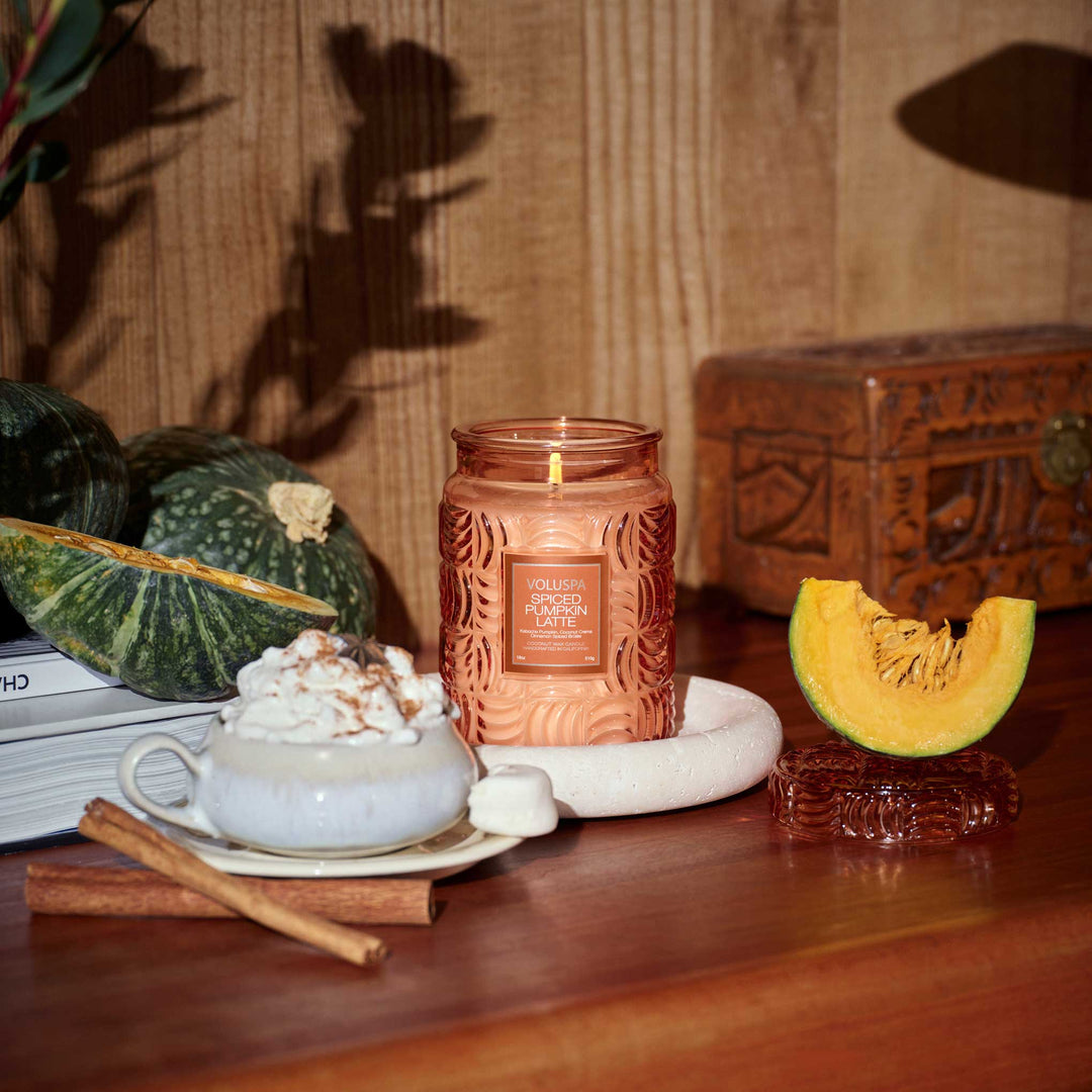 Voluspa Spiced Pumpkin Latte candle collection styled on a wooden coffee table for fall