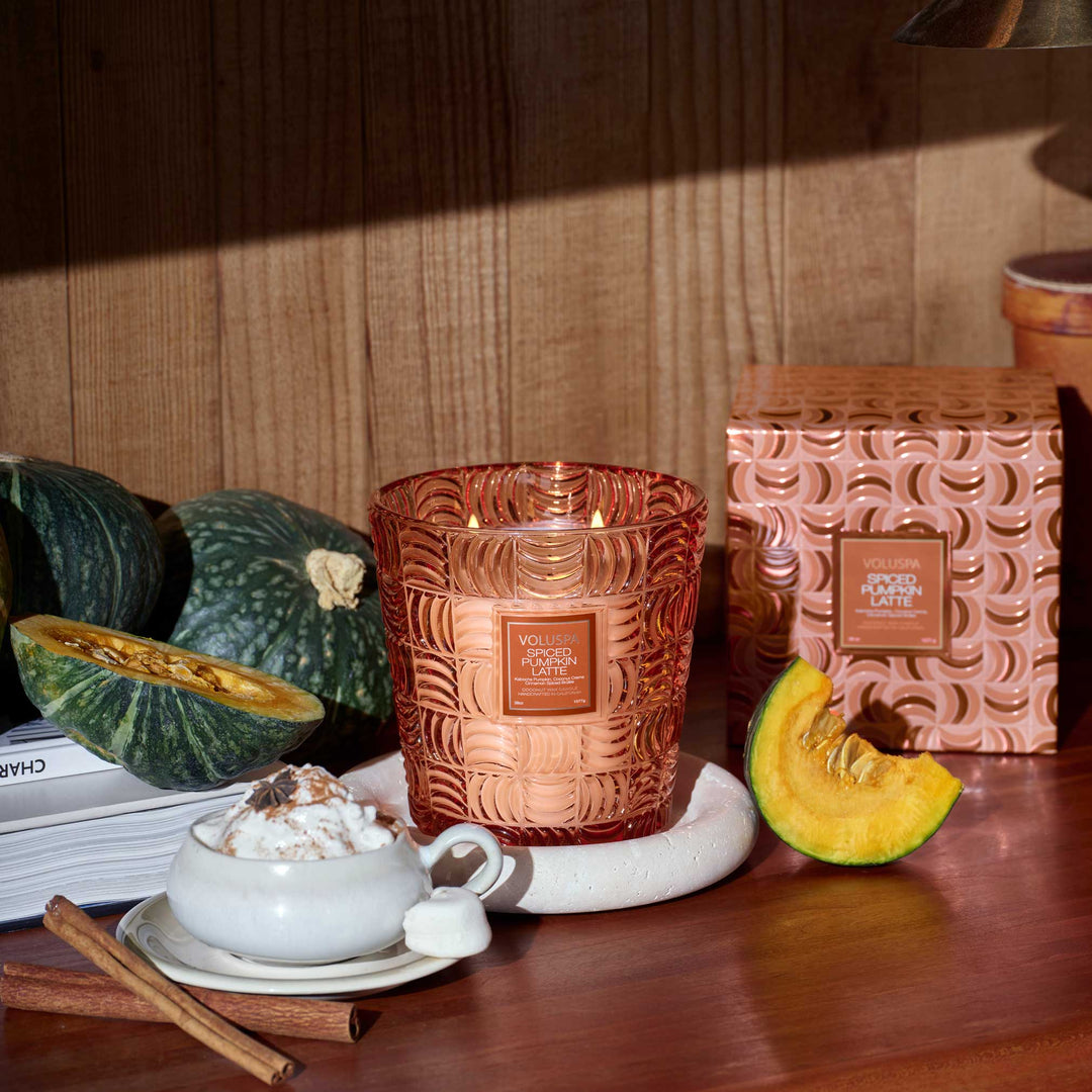 Voluspa Spiced Pumpkin Latte 3 Wick Hearth Candle styled with pumpkin, cinnamon sticks and a pumpkin latte