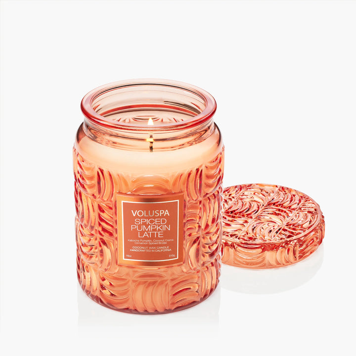 Lit Voluspa Spiced Pumpkin Latte Large Jar Candle with embossed glass lid beside it