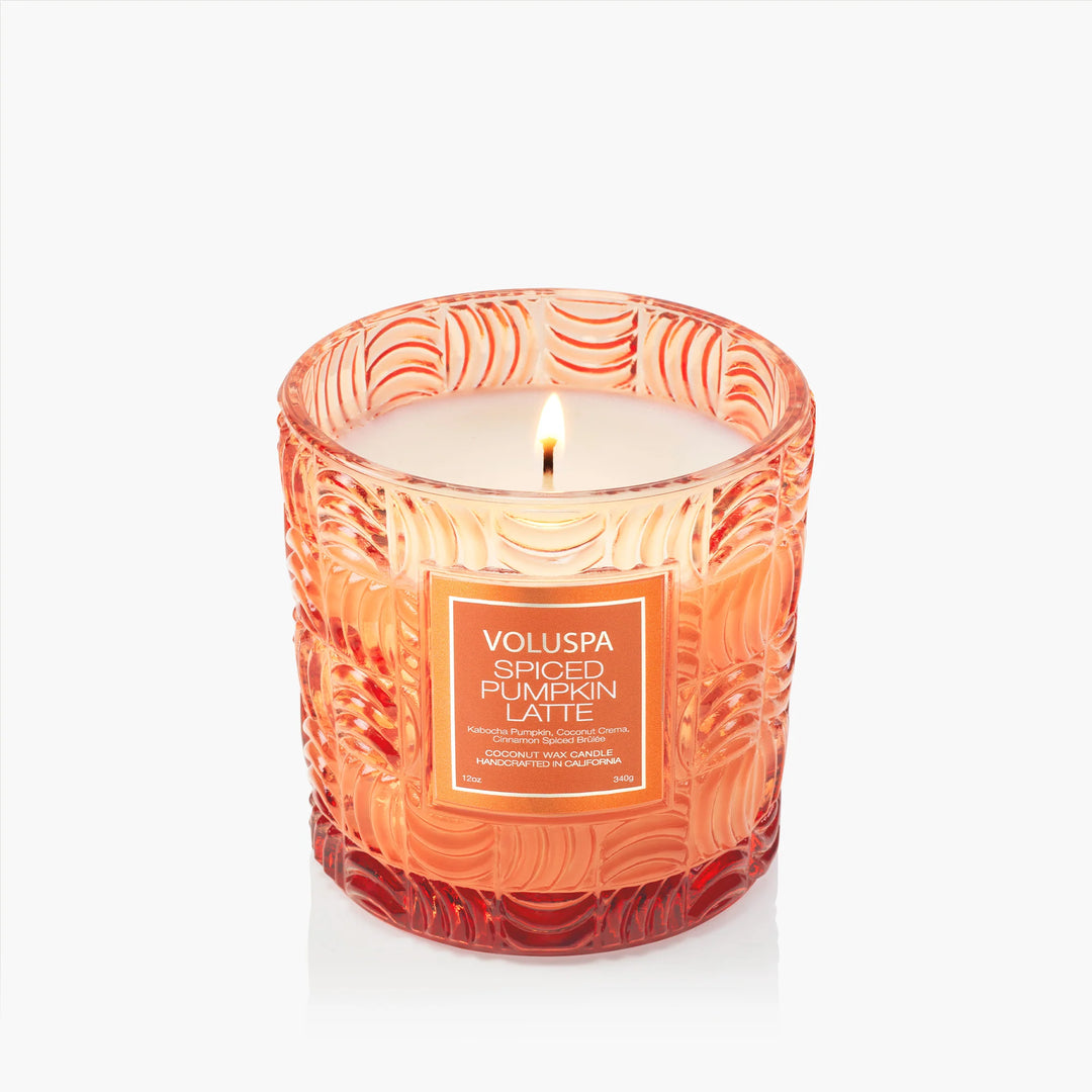 Lit Voluspa Spiced Pumpkin Latte Luxe Classic Candle in embossed orange glass vessel