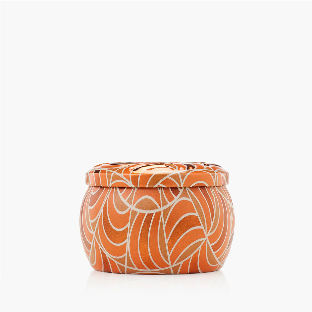 Closed Voluspa Spiced Pumpkin Latte Mini Tin Candle in orange and cream patterned tin