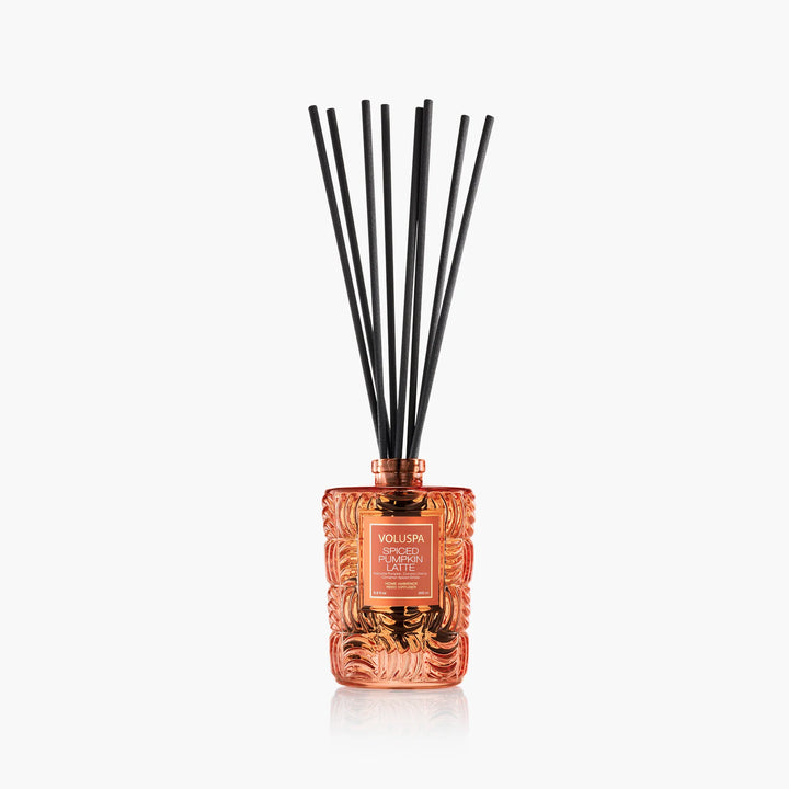 Voluspa Spiced Pumpkin Latte Reed Diffuser in embossed orange glass vessel with black reeds