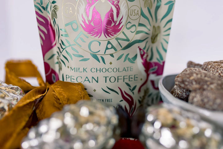 Zorro Milk Chocolate Pecan Toffee with gourmet toffee pieces and festive holiday decorations.